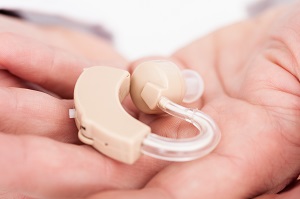 Close-up Of A Hearing Aid On Person;s Palm